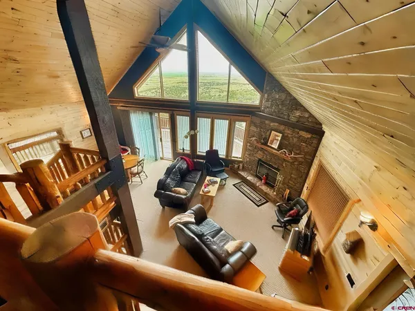 a view of living room with furniture and floor to ceiling window