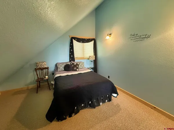 a bedroom with a bed and chair