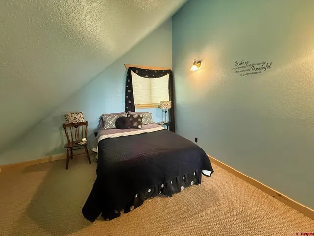 a bedroom with a bed and chair