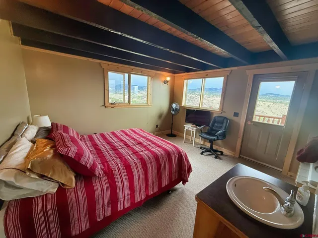 a bed sitting in a bedroom next to a window