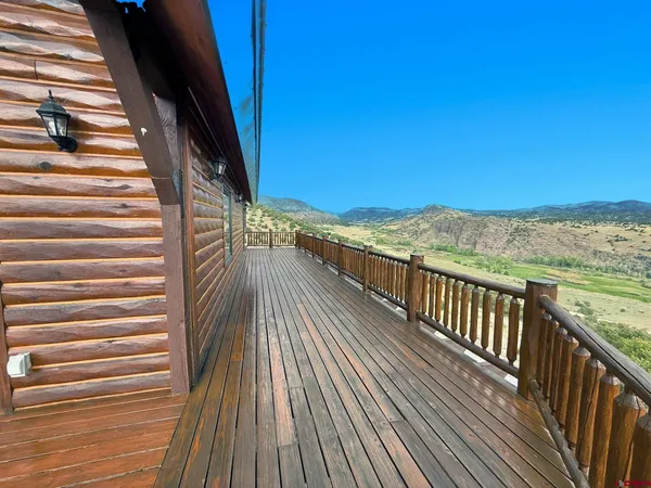 a view of balcony with wooden floor and fence