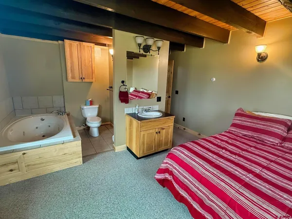 a bedroom with 2 bed and a window