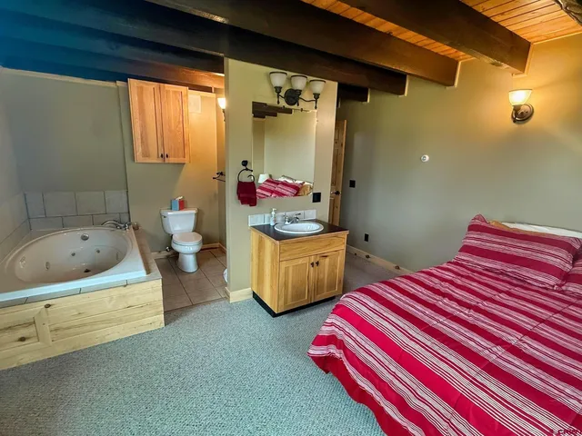 a bedroom with 2 bed and a window