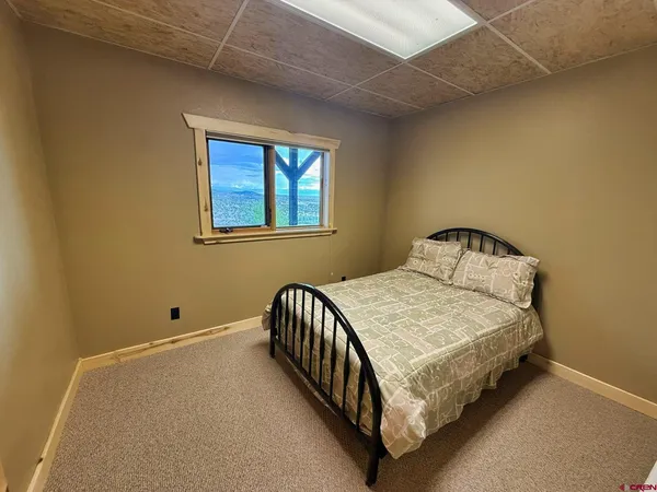 a bedroom with a bed and window