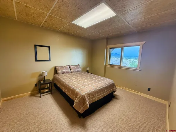 a bed sitting in a room next to a window