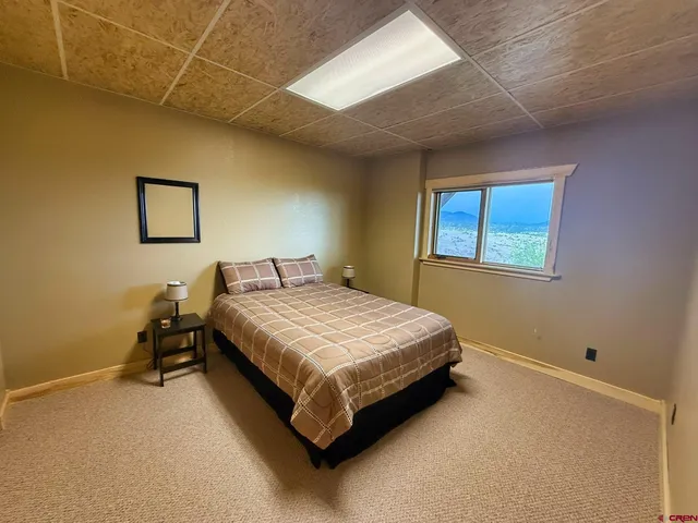 a bed sitting in a room next to a window