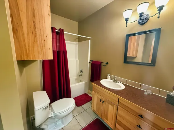 a bathroom with a sink vanity mirror and toilet