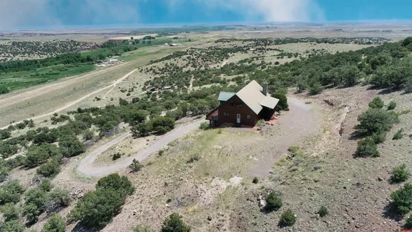 an aerial view of house with yard