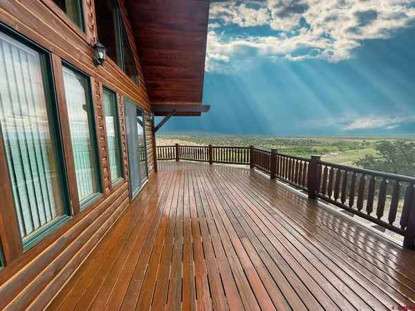 a view of balcony with wooden floor