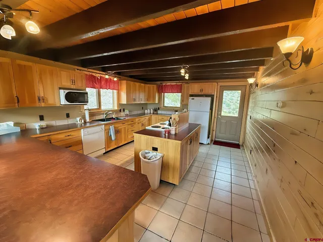 a kitchen with stainless steel appliances granite countertop a sink and cabinets