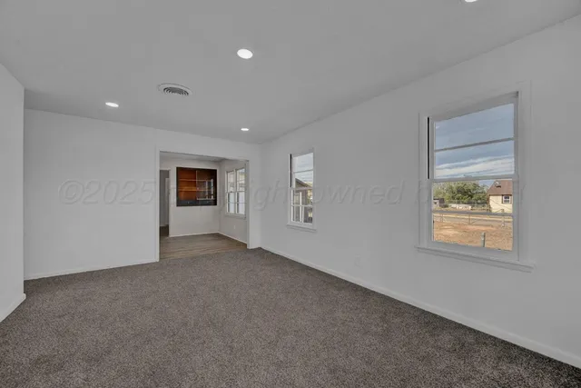 a view of an empty room with a window