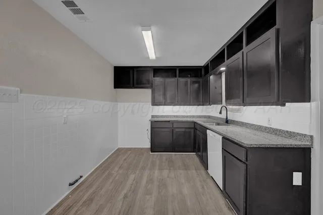 a kitchen with a sink and cabinets
