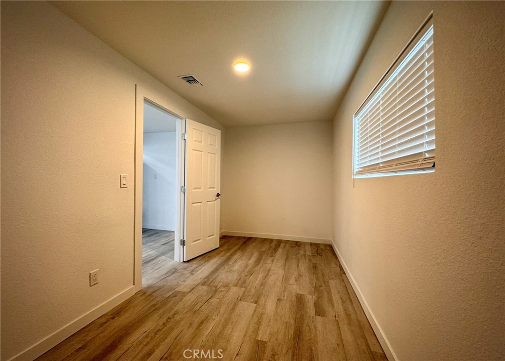 1362 South Downey Road Los Angeles, CA 90023 - Photo 18 of 30 an empty room with wooden floor and windows