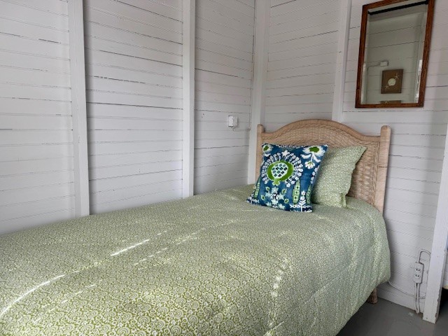 24 Washington Avenue Nantucket, MA 02554 - Photo 6 of 9 a large bed sitting in a bedroom next to a white cabinet