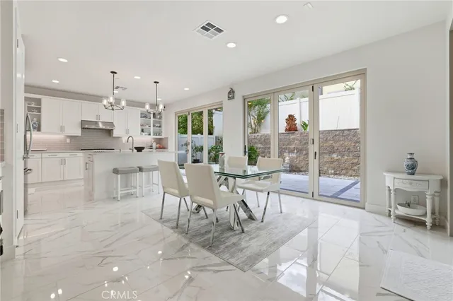 a large kitchen with kitchen island a large window cabinets and stainless steel appliances