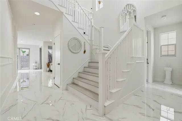 a view of entryway with furniture and wooden floor