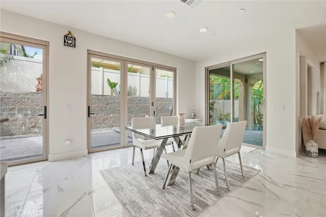 a view of a dining room with furniture and a window