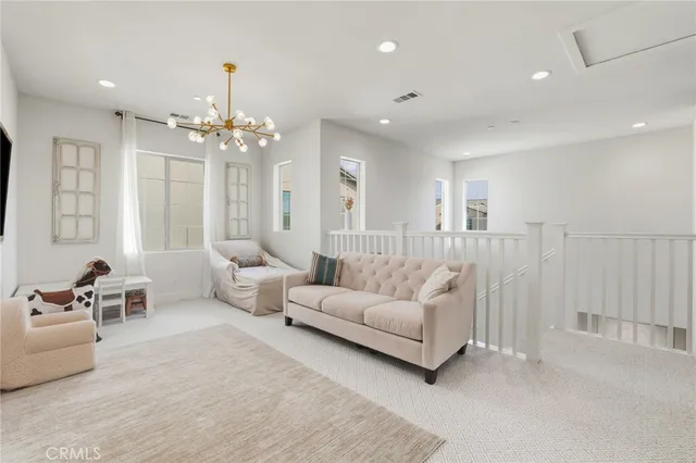 a living room with furniture and a chandelier