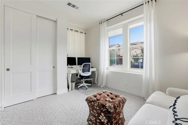 a bedroom with a bed and a chair in it