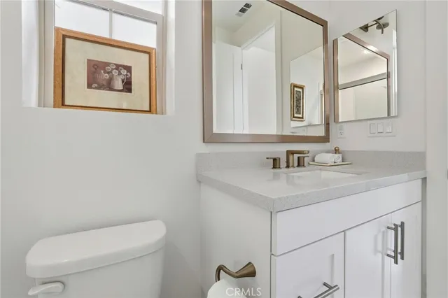 a bathroom with a sink double vanity and a mirror