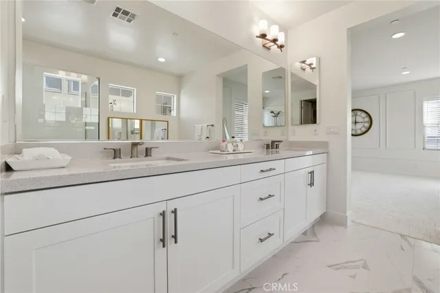 a bathroom with a tub sink and mirror