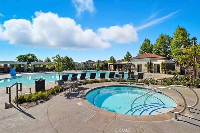 a view of a swimming pool with an outdoor seating and a many windows