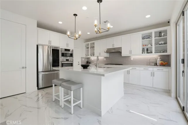 a kitchen with a refrigerator a sink and cabinets