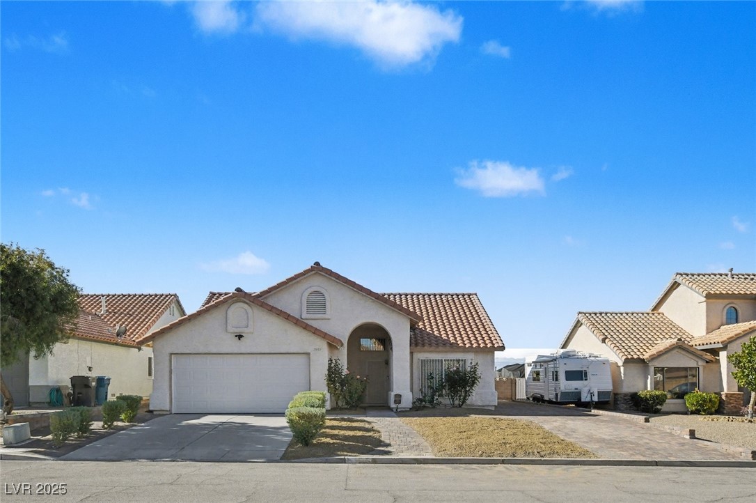 7951 Aspendale Drive Las Vegas, NV 89123 - Photo 1 of 42 Mediterranean / spanish-style house featuring concrete driveway, stucco siding, a garage, and a tiled roof