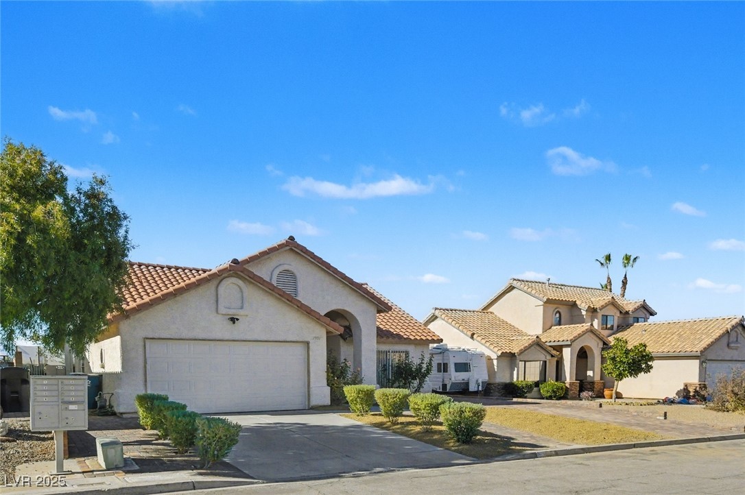 7951 Aspendale Drive Las Vegas, NV 89123 - Photo 2 of 42 Mediterranean / spanish home featuring stucco siding, driveway, an attached garage, and a residential view