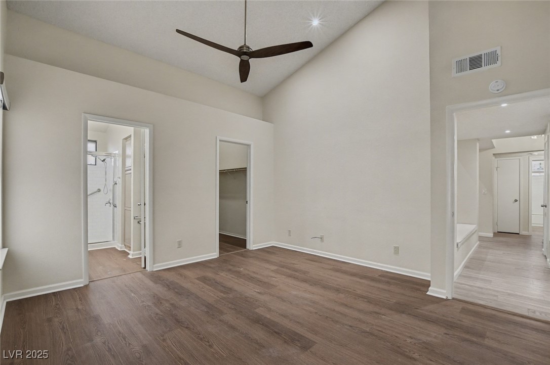 7951 Aspendale Drive Las Vegas, NV 89123 - Photo 21 of 42 Unfurnished bedroom featuring high vaulted ceiling, dark wood-style flooring, a walk in closet, recessed lighting, and ceiling fan
