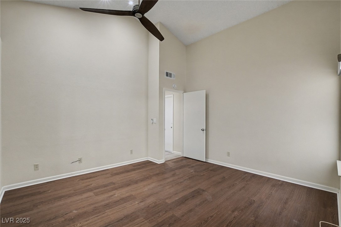 7951 Aspendale Drive Las Vegas, NV 89123 - Photo 22 of 42 Unfurnished room featuring high vaulted ceiling, dark wood finished floors, and a ceiling fan