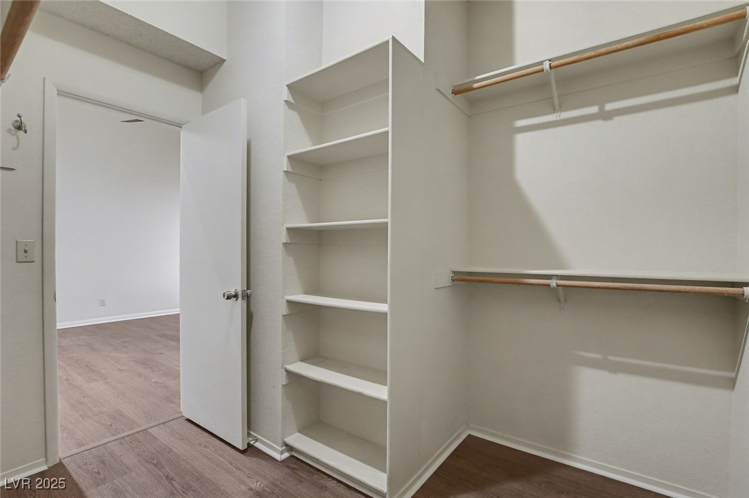 7951 Aspendale Drive Las Vegas, NV 89123 - Photo 23 of 42 Spacious closet with dark wood finished floors