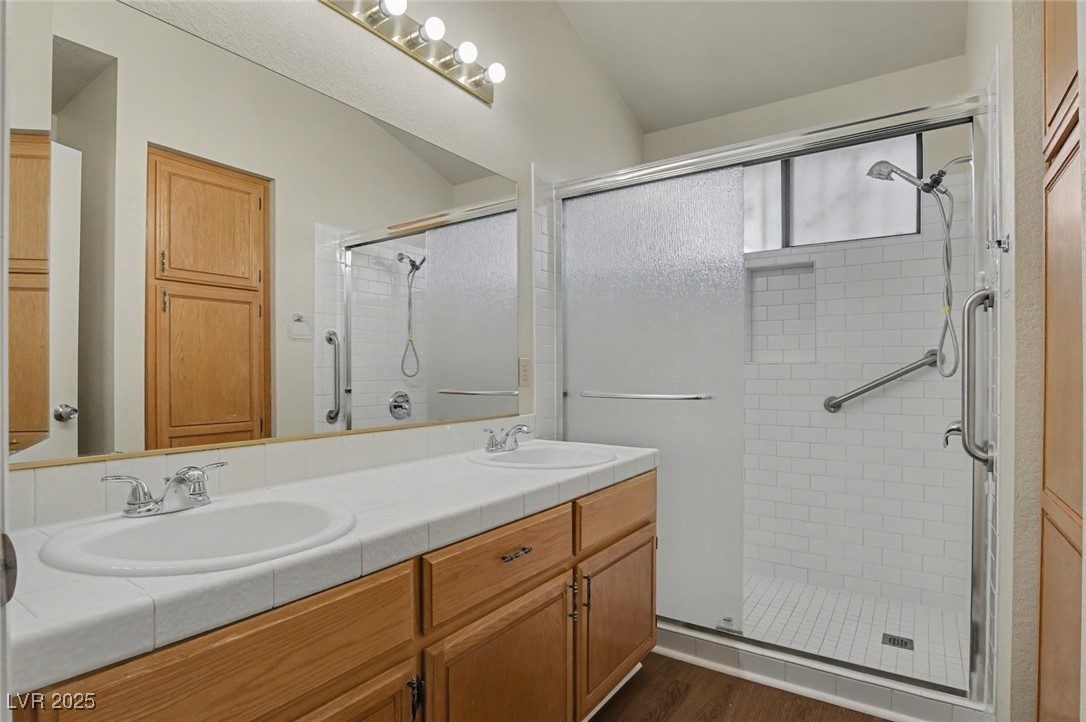7951 Aspendale Drive Las Vegas, NV 89123 - Photo 25 of 42 Full bath with double vanity, a stall shower, and dark wood-style floors
