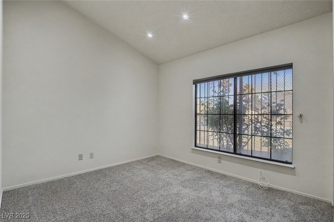 7951 Aspendale Drive Las Vegas, NV 89123 - Photo 26 of 42 Empty room featuring lofted ceiling, carpet flooring, and recessed lighting