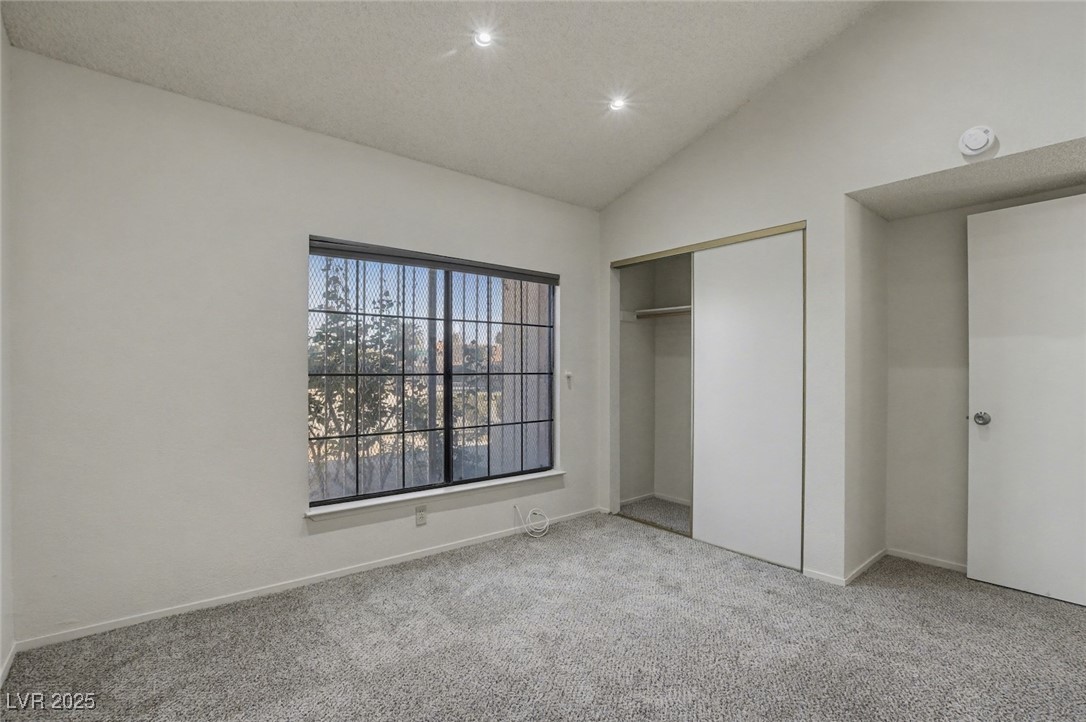 7951 Aspendale Drive Las Vegas, NV 89123 - Photo 27 of 42 Unfurnished bedroom featuring vaulted ceiling, carpet floors, a closet, recessed lighting, and a textured ceiling
