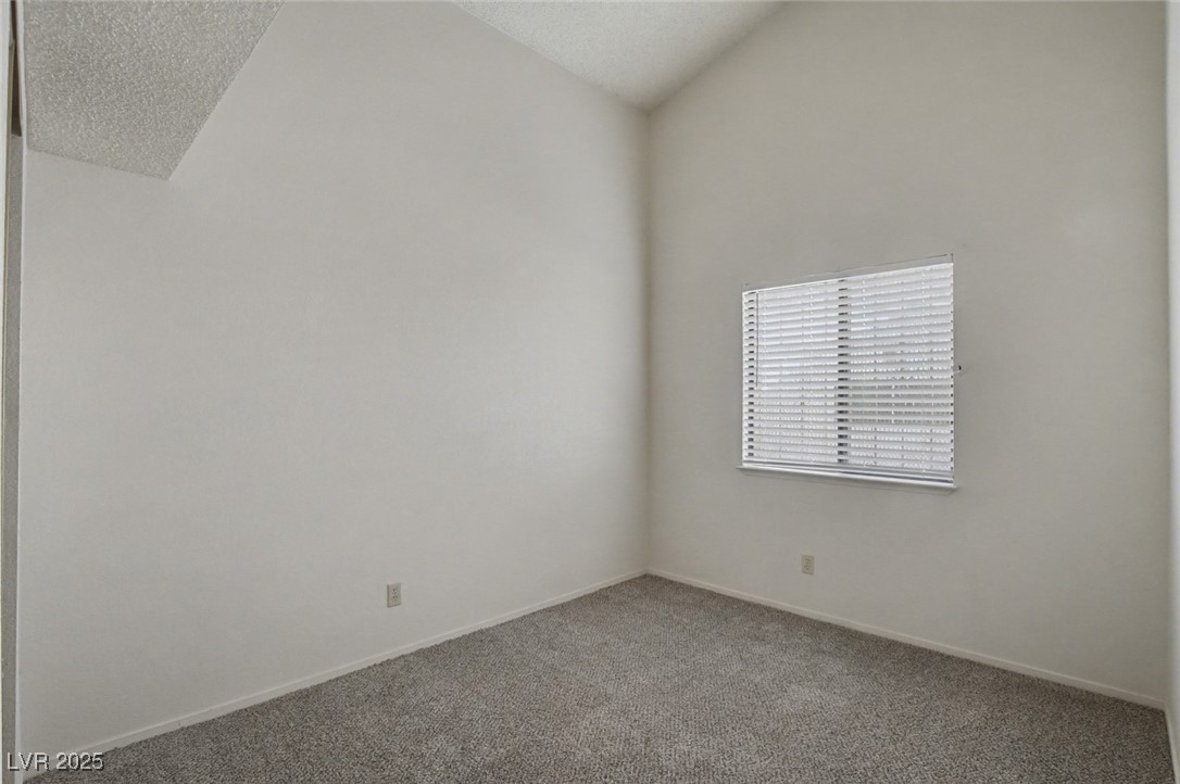 7951 Aspendale Drive Las Vegas, NV 89123 - Photo 29 of 42 Unfurnished room featuring vaulted ceiling, carpet, and a textured ceiling