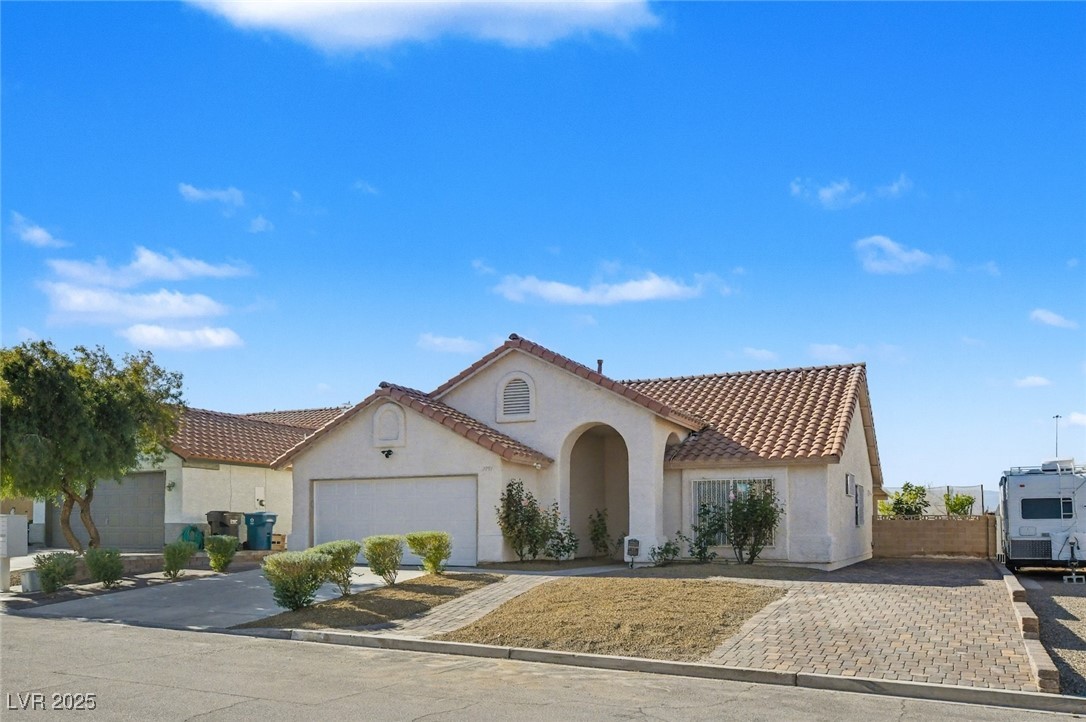7951 Aspendale Drive Las Vegas, NV 89123 - Photo 3 of 42 Mediterranean / spanish house with stucco siding, driveway, a tiled roof, and a garage