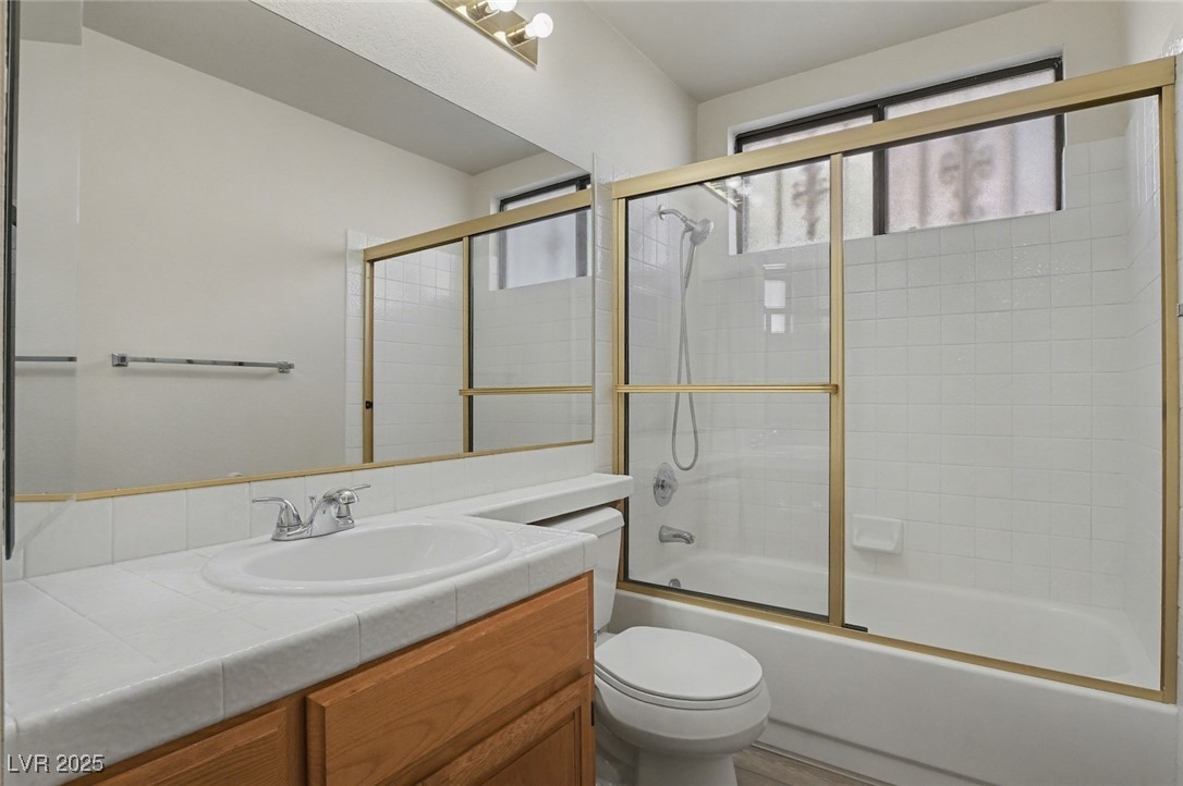7951 Aspendale Drive Las Vegas, NV 89123 - Photo 32 of 42 Full bath with vanity and shower / bath combination with glass door