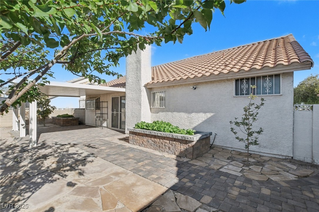 7951 Aspendale Drive Las Vegas, NV 89123 - Photo 37 of 42 Rear view of house with stucco siding, a patio area, and a tiled roof