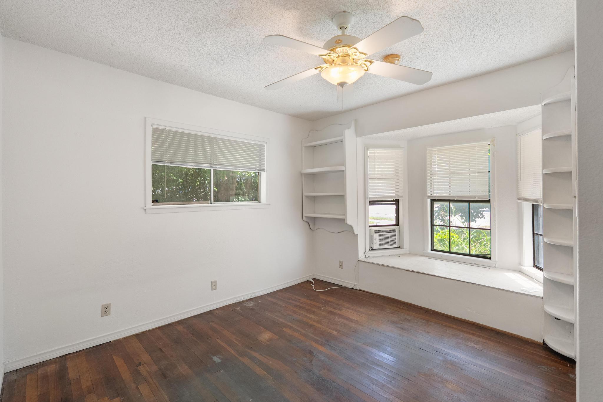 4616 East Cesar Chavez Street Austin, TX 78702 - Photo 21 of 22 a view of an empty room with a window and wooden floor