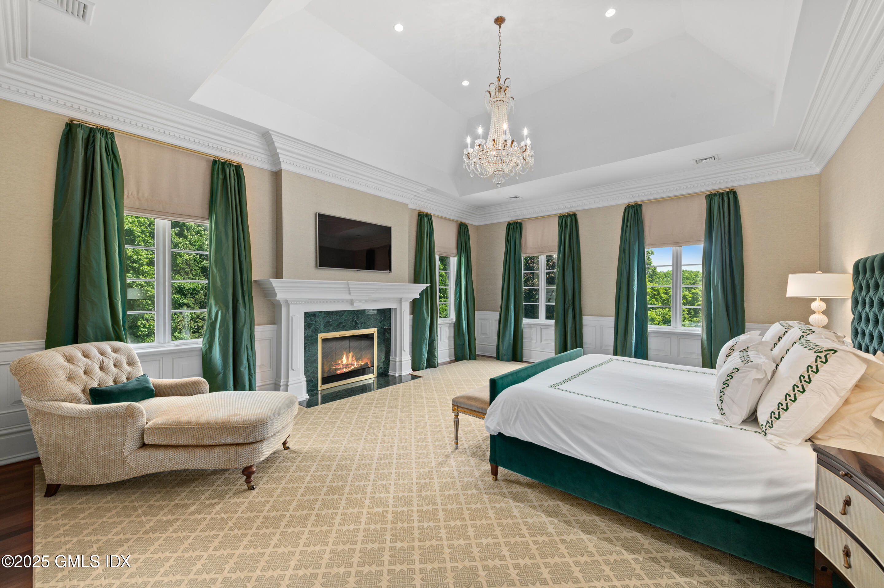 537 North Street Greenwich, CT 06830 - Photo 13 of 27 a spacious bedroom with a bed and a fireplace