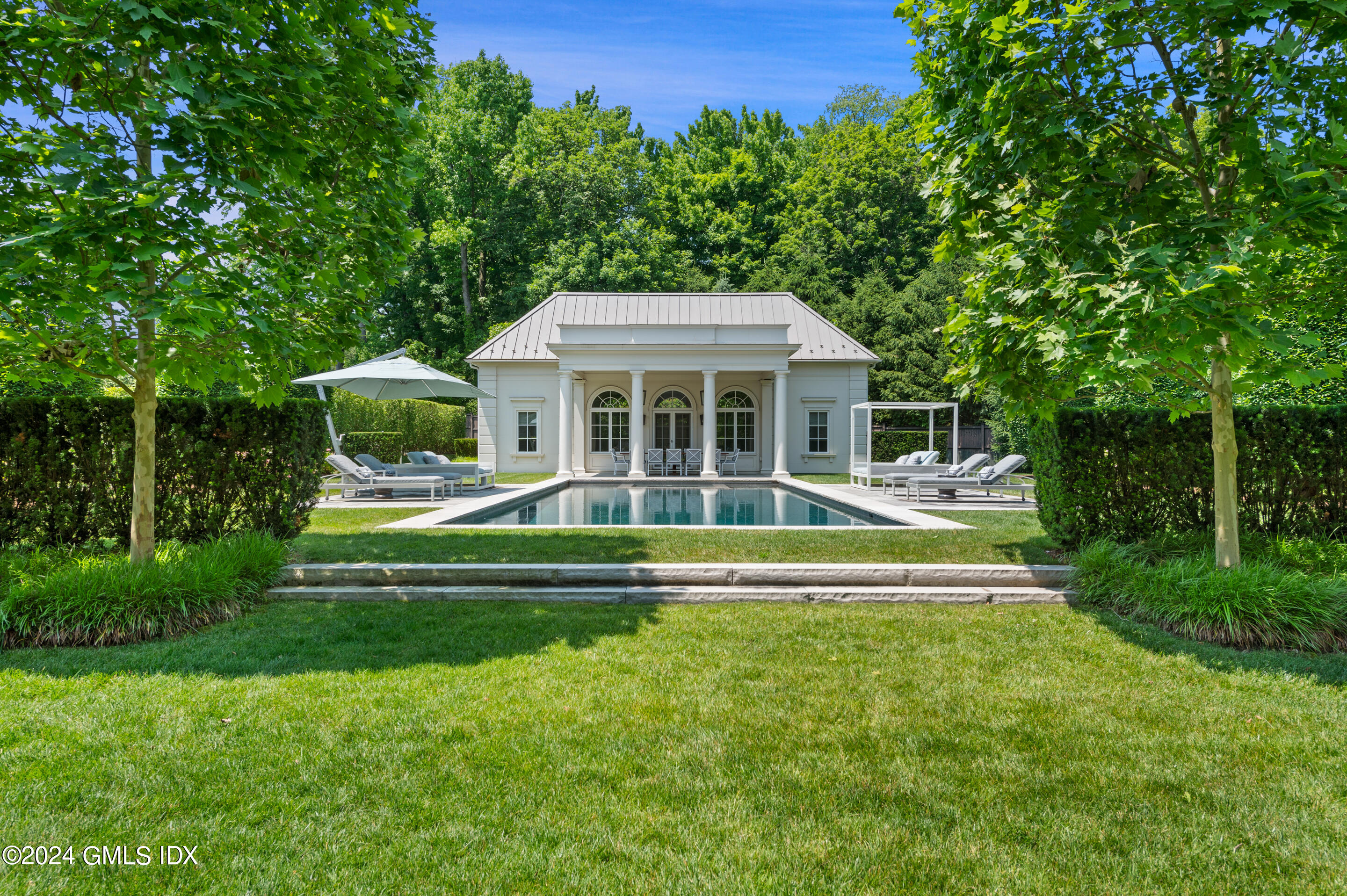 537 North Street Greenwich, CT 06830 - Photo 22 of 27 a view of a house with a swimming pool
