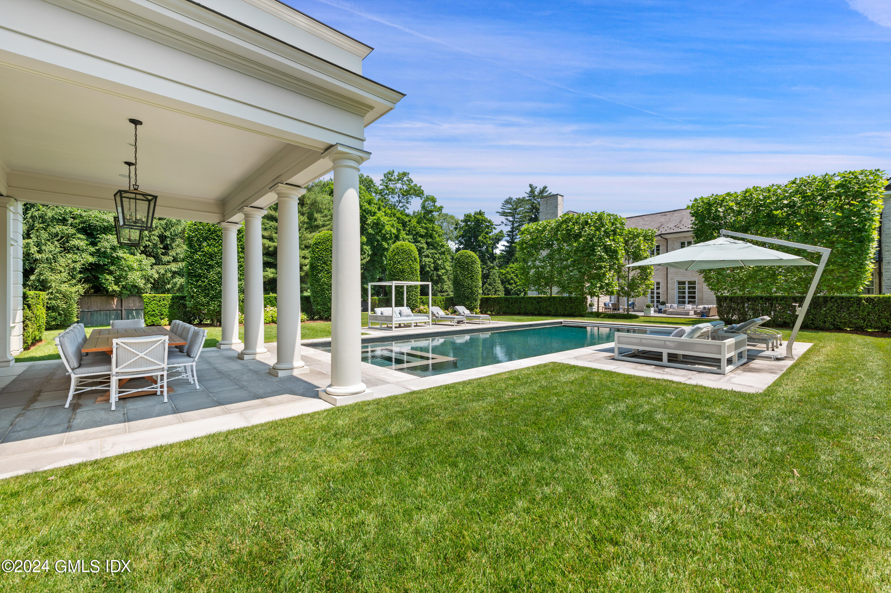 537 North Street Greenwich, CT 06830 - Photo 25 of 27 a view of a house with backyard porch and sitting area