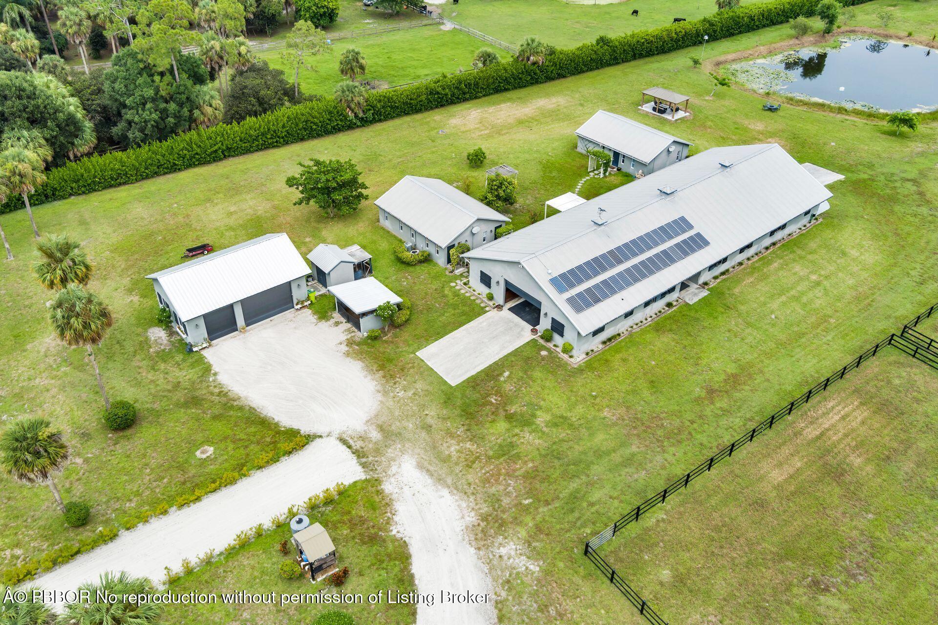 2770 E Road Loxahatchee, FL 33470 - Photo 51 of 51 an aerial view of a house with swimming pool and garden