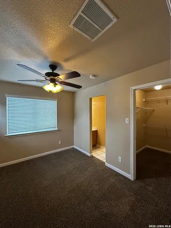 a view of an empty room with a fan