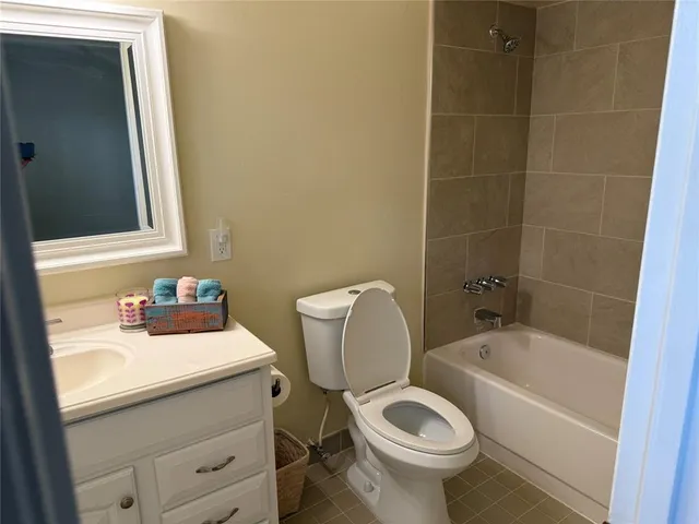 a bathroom with a sink a toilet and bathtub