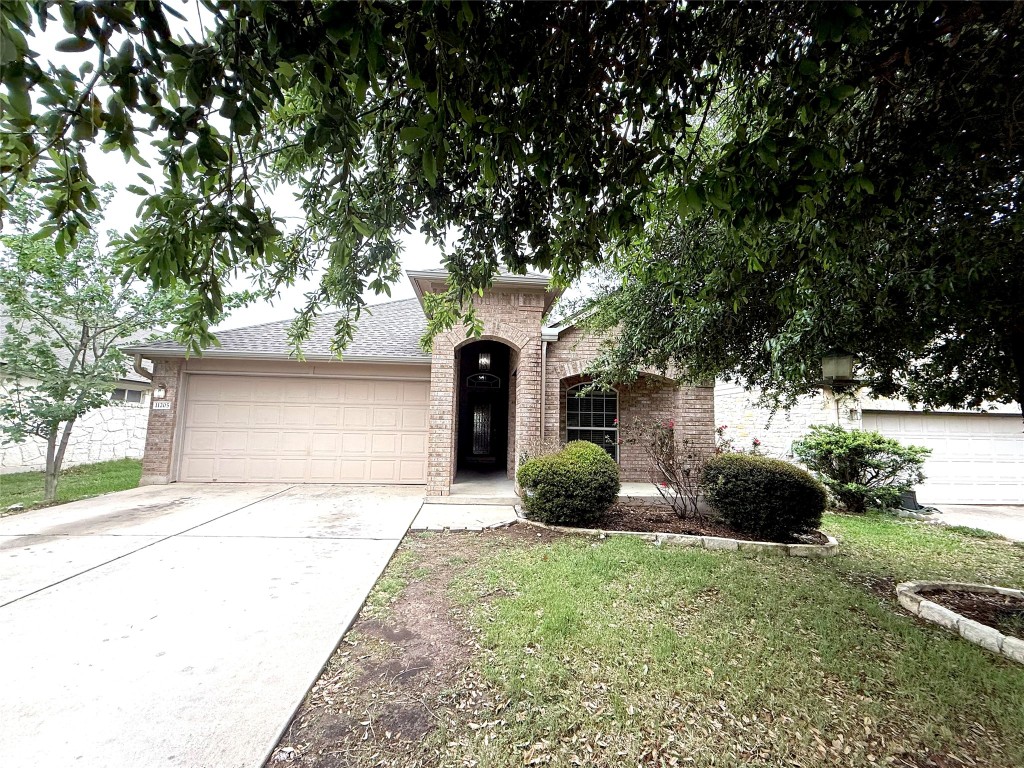 a front view of a house with a yard and garage