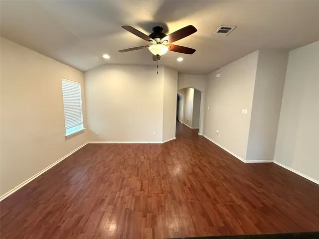 a view of an empty room and wooden floor