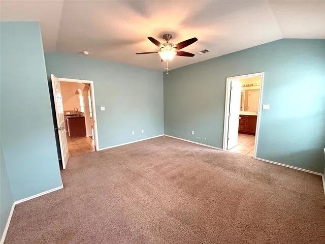 a view of a livingroom with a ceiling fan and window