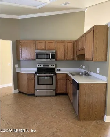 a kitchen with stainless steel appliances a stove sink and microwave